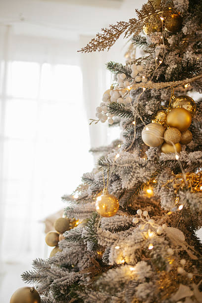 istock Golden Ornaments on Flocked Tree 2238900730