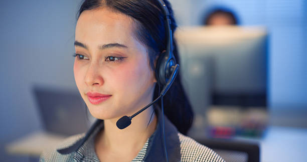 istock Asian woman with headset working at call center office during night shift. 2238901344