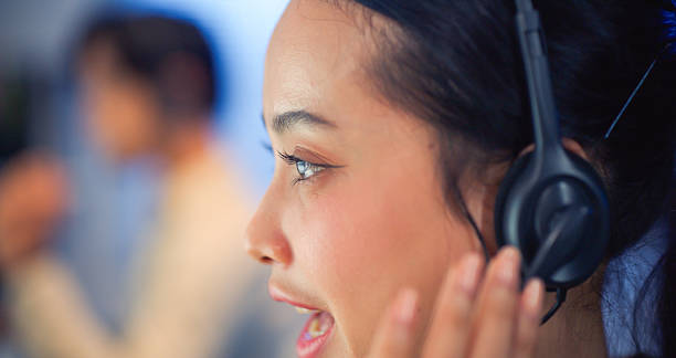 istock Asian Female Call Center Agent With Headset Talking At Night. 2238901370