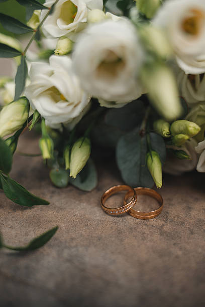 istock Gold Rings Near White Roses Bouquet 2238901511