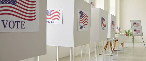 istock Row of a Voting Booths with American Flags 2238901865