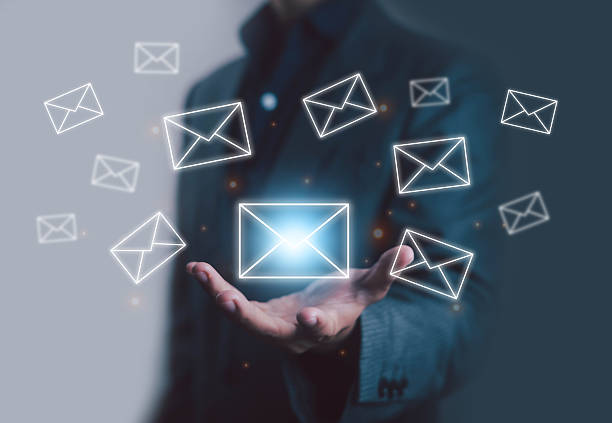 istock Businessman hand holding multiple glowing email icons, digital inbox communication, online messaging, business correspondence, electronic mail exchange, marketing campaign, networking, information 2238902831
