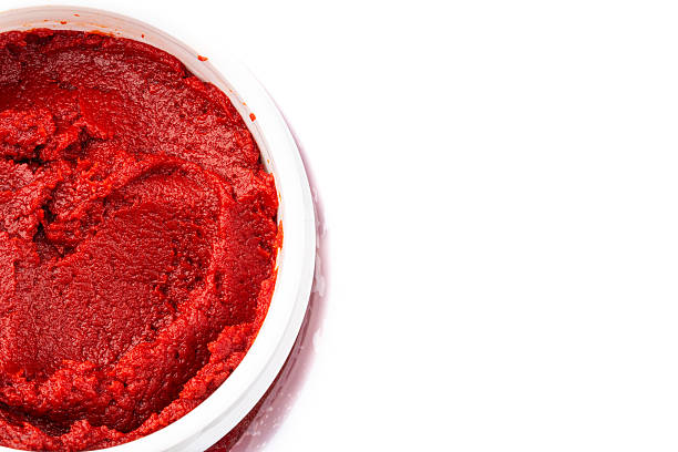 istock Tomato or pepper paste or puree prepared to add flavor to dishes on a white background 2238904852