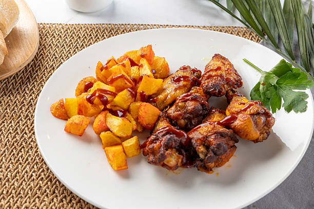 Chicken wings and roasted potatoes with barbecue sauce