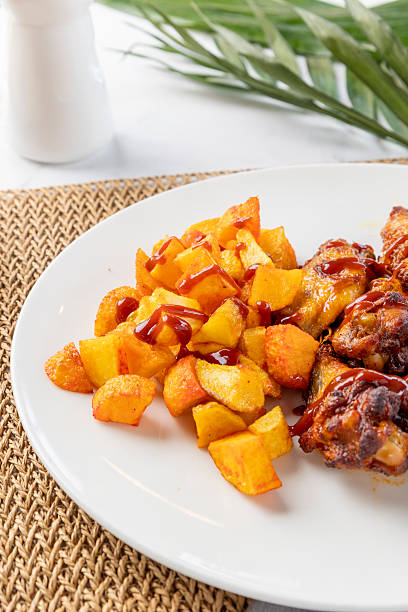 Chicken wings with barbecue sauce and roasted potatoes