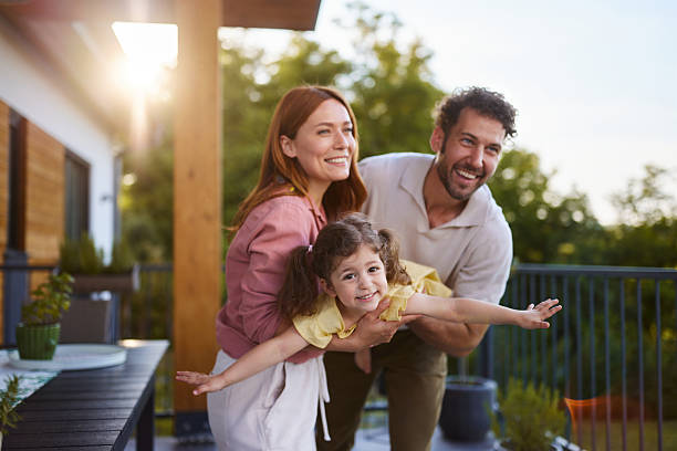 istock Happy parents having fun wit their girl on a terrace. 2238909833