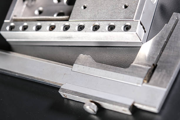 istock Close up of a precision linear motion guide rail with metal screws and a caliper on a black background. 2238911178