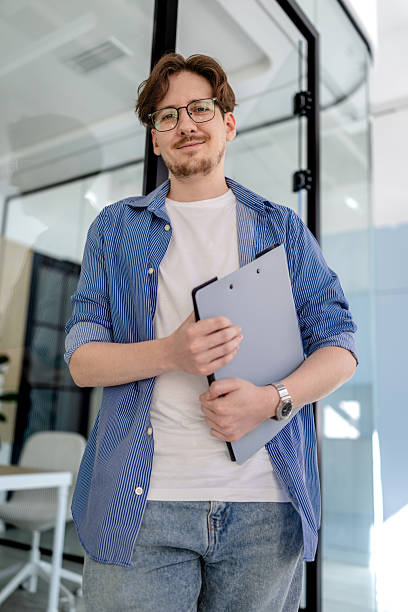 istock Young businessman confidently working in a modern office setting with technology in use 2238914239