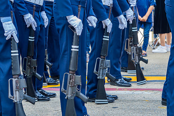 Soldiers parade with their service rifles.
