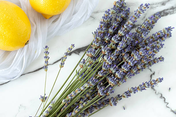 istock Bunch of lavender and lemons on white marble background 2238916753