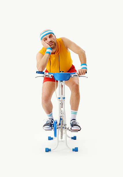 istock Exhausted man exercising on the stationary bike 2238918364