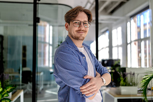istock Young man in a modern office smiling confidently while working on freelance business tasks 2238920537