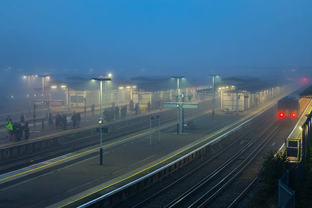 Early morning still dark tick fog train station platform. People waiting for a train in the morning in thick fog , the image feel authentic and real natural weather condition.