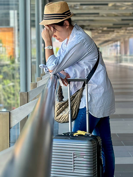 istock Airline Disruption: Woman Awaits Assistance with Concerned Look 2238921461