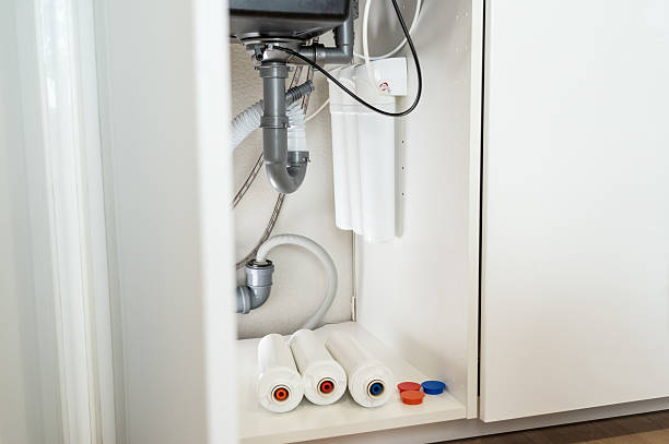 istock Installation water purifier. Replacement water filter with cartridges in kitchen 2238922064