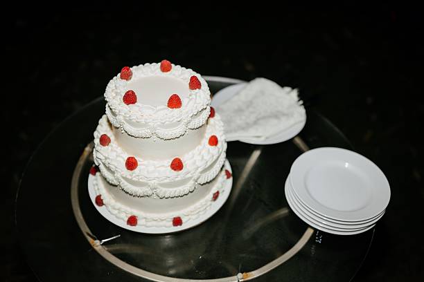 istock Elegant Three-Tier Wedding Cake with Raspberries 2238923866
