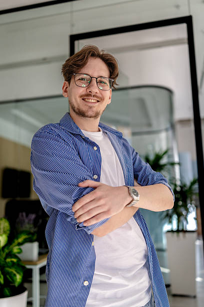 istock Young professional smiling confidently in a modern office environment during freelance work 2238925097