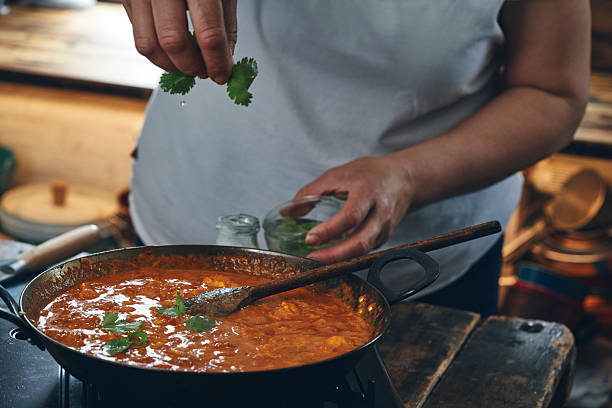 istock Preparing Indian Chicken Curry with Naan Bread and Pappadom 2238925137