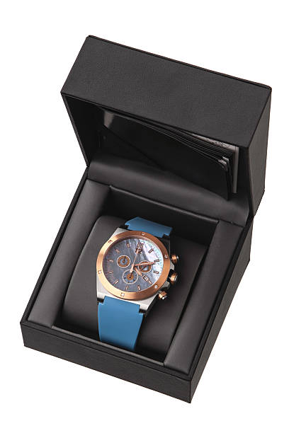 istock Luxury silver and rose gold chronograph watch with a blue rubber strap, presented in an open black gift box. 2238925721