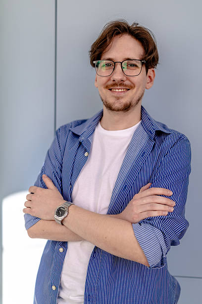 istock Young white man smiles confidently in modern office while engaging in freelance work 2238926069