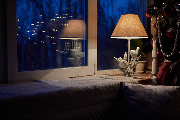 A warm, inviting space with a lovely lamp by the window reflecting evening lights for a relaxing atmosphere