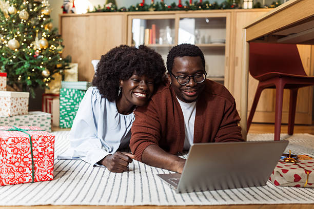 istock Young couple using laptop at home during Christmas 2238929515