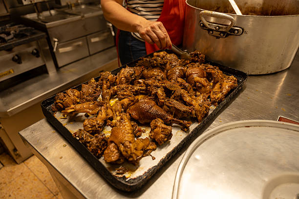 istock Cook arranging roasted chicken pieces on baking tray in restaurant kitchen 2238931013