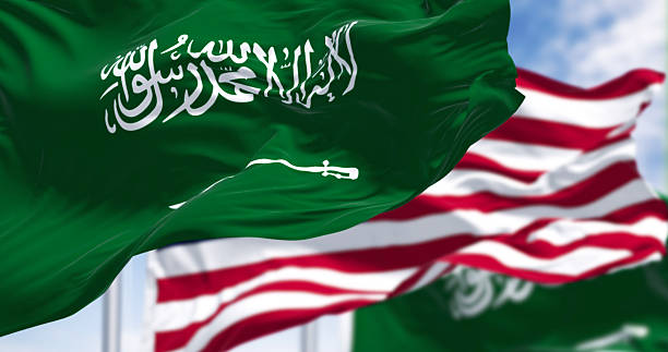 istock Saudi Arabian and American flags waving together in sky, 3D render 2238934724
