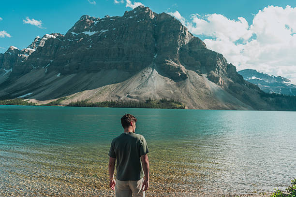 istock Person Admiring Mountain Lake Scenery 2238936038