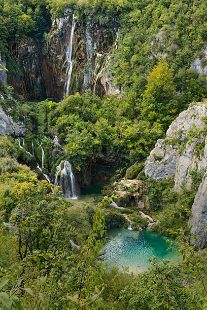 istock breathtaking natural paradise featuring cascading waterfalls, turquoise pools, lush greenery, and dramatic cliffs. 2238936606