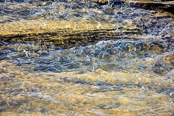 istock nature texture with stones in the water steam 2238939357