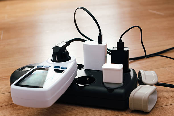 istock Overloaded power adaptor multiple socket. Surge Protector Power Strip, Phone Charger Cable. Plugs in Outlet 2238941348