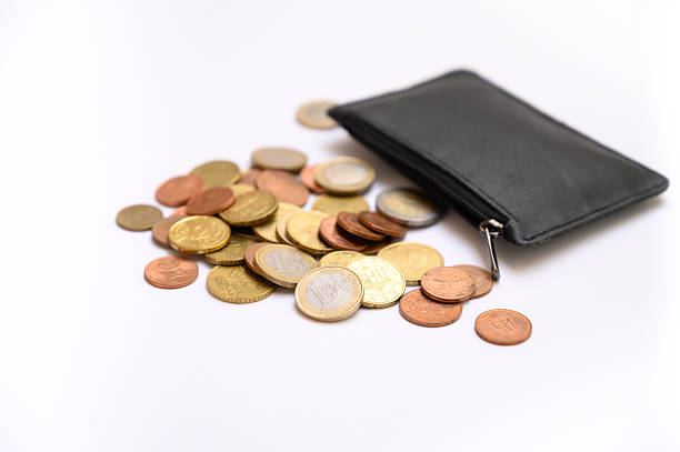 Euro coins scattered from an open black wallet on white background. Concept photo for finance, savings, expenses, economy, payments, personal budget planning, money management, and crisis symbol with copy space.