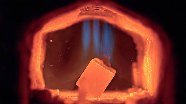 Close up shot of high heat inside a metalworking forge with vibrant fire and sparks in a blacksmith workshop featuring intense flames and glowing metal.