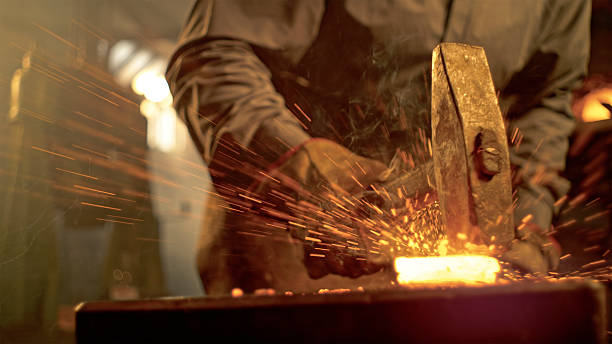 istock Caucasian Mid Adult Male Blacksmith Creating Metalwork in Workshop 2238942367