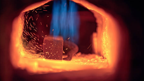 High heat inside metalworking forge with fire and sparks in blacksmith workshop featuring glowing embers and vibrant blue flames.