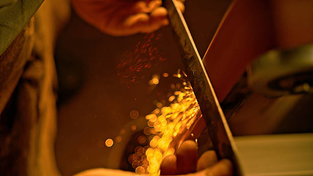 istock Blacksmith Grinding Metal with Sparks Flying 2238942414