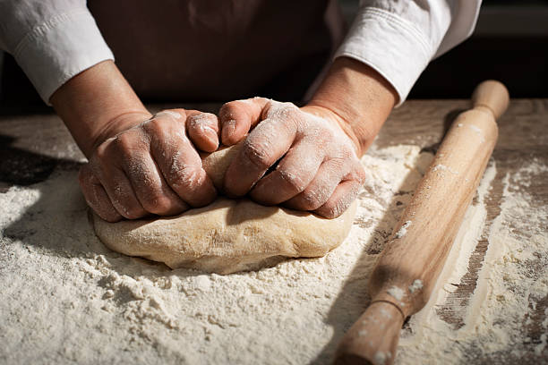 istock Baking concept. Caucasian female hands kneading the dough. 2238943454