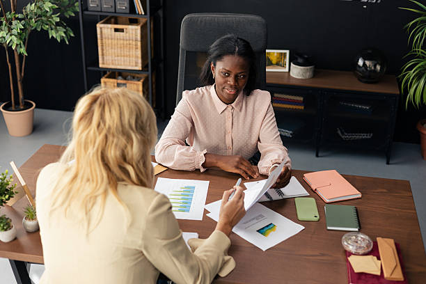 istock Businesswomen discussing finance report analyzing company data 2238944364