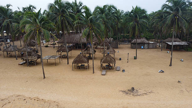 istock Picturesque beach scene with thatched huts and palm trees creating a relaxing vibe 2238946096