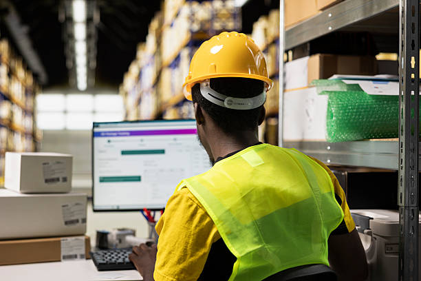 istock Warehouse worker focusing on supply chain logistics with tracking software 2238946435
