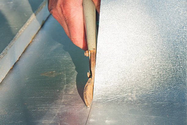 istock A worker cuts a sheet of tin with metal shears 2238946920