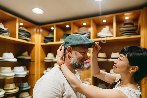 istock A couple trying on hats in a Hat Shop 2238951061