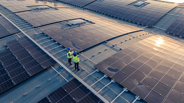istock Engineers Inspecting Solar Installation Efficiency on Factory Rooftop 2238951980