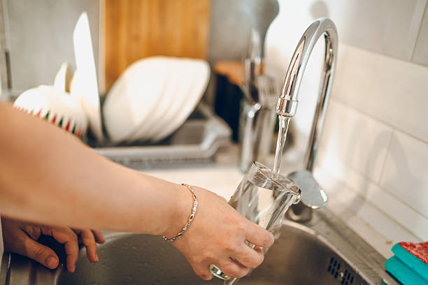 istock Woman washes the dishes 2238952809