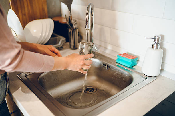 istock Woman washes the dishes 2238952865
