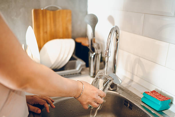 istock Woman washes the dishes 2238952959
