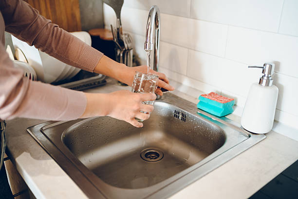 istock Woman washes the dishes 2238952979