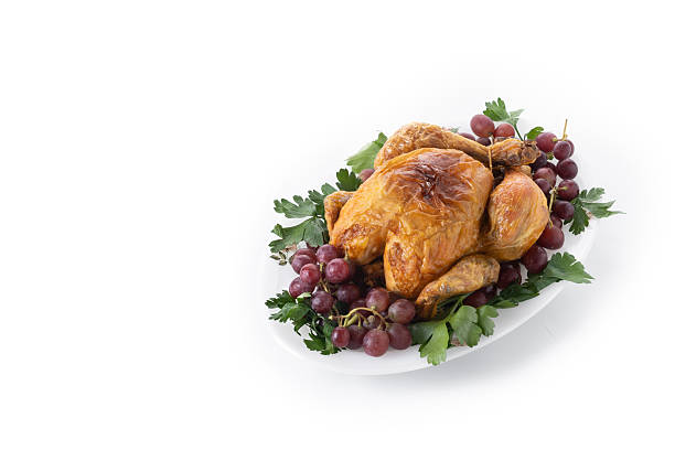 istock Roast turkey with grapes and parsley on white plate 2238953763