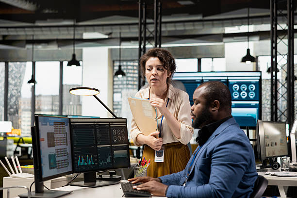 istock Multiethnic work team consulting each other in completing monthly reports 2238954684